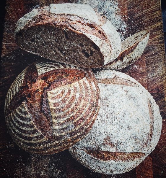 High-angle close-up view of several loaves of artisan bread